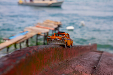 Model yellow taxi left on the beach