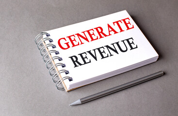 GENERATE REVENUE word on notebook on grey background