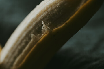 Close-up of peeled bananas on a dark background