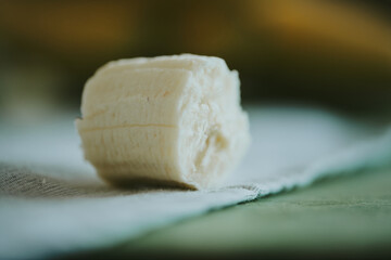 Close-up of peeled sliced banana on wooden table background