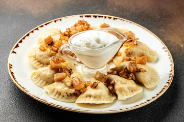Dumplings with fried onions. Varenyky, vareniki, pierogi, pyrohy with filling, top view