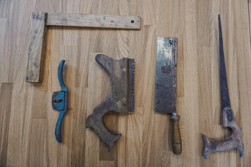 Old tools in the carpentry shop on the wooden table - craftsmanship - joiner