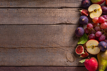 Autumn fruit assortment on wooden background
