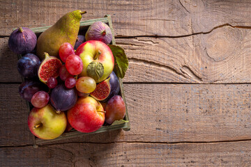 Autumn fruit assortment on wooden background