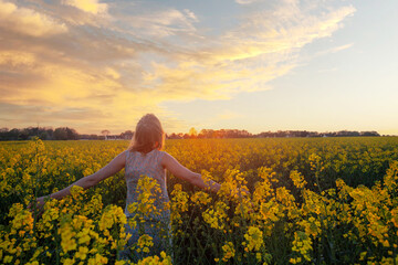 wellness, woman in flower field in nature, wellbeing