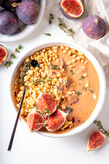 Healthy breakfast bowl with granola and figs