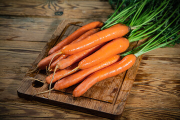 Fresh carrots on wooden table.