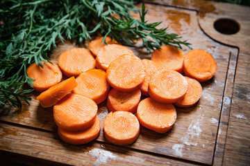 Fresh chopped carrots on cutting board.