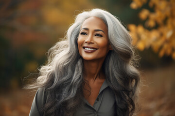 Naklejka premium Generative AI image of happy beautiful woman walking in the park blurred forest and orange dry leaves background