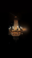 Fototapeta na wymiar Old vintage luxury chandelier on dark background. AI generative