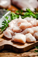 Sliced chicken fillet. On cutting board.