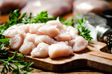 Sliced chicken fillet. On cutting board.