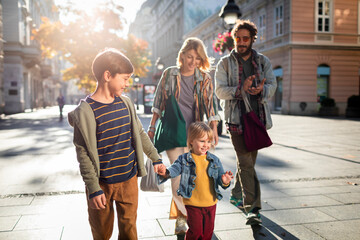Young family having a stroll together in the city