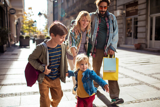 Young family walking and shopping in the city