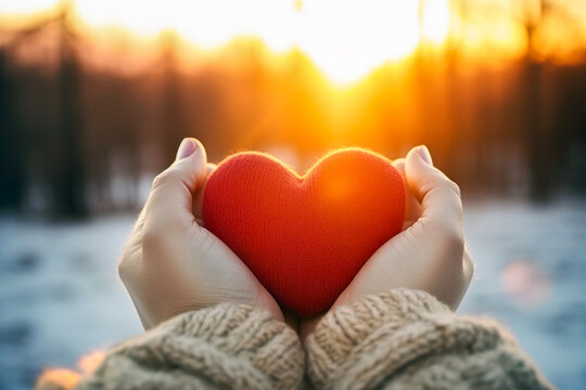 Close up of woman holding heart symbol shaped in background of winter view. Lifestyle concept of drinks and rest.