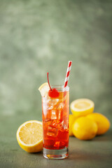 Fresh summer cocktail limoncello sunrise in a glass with lemon and  cherries