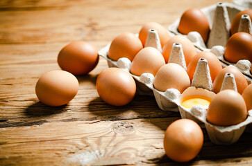 Chicken eggs on wooden table.