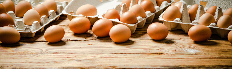Chicken eggs on wooden table.