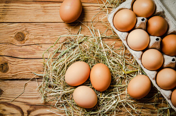 Chicken eggs on wooden table.