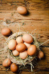 Chicken eggs in a plate on wooden table.