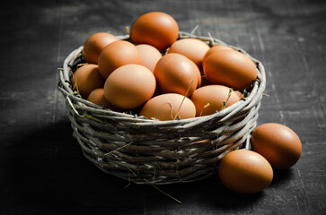 Fresh chicken eggs in basket.