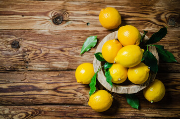Fresh lemons. On wooden table.