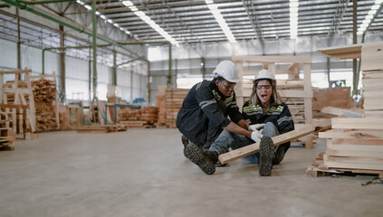 Female engineer injured from accident lying on floor crying with pain in warehouse. Male worker emergency help colleague who falling down get physical injury in workplace. Risk, dangerous in workplace
