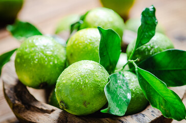 Fresh limes. On wooden table.