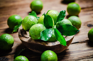 Fresh limes. On wooden table.