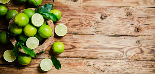 Fresh limes. On wooden table. - 660994725