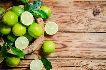 Fresh limes. On wooden table.