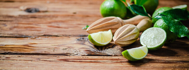 Fresh limes. On wooden table.