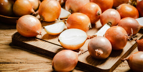 Fresh onions on table .