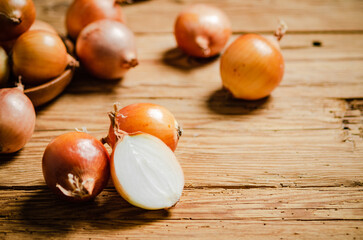 Fresh onions on table .