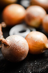 Fresh onions . On table