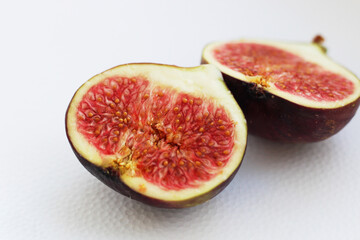 Fig fruits cut on a plate, juicy ripe flesh with seeds