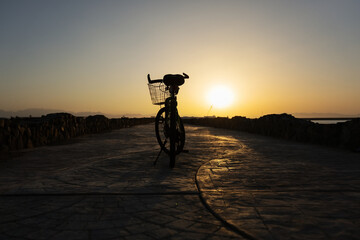 Bicycle silhouette at sunset sky