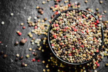 Peppercorn on rustic background.
