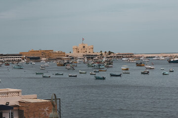 Boats on the water in Qaitbay harbour in Alexandria Egypt