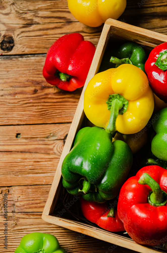 Poster fresh sweet pepper. on wooden table.