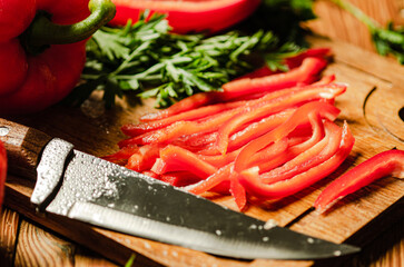 Chopped sweet pepper. On wooden table.