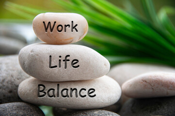 Work life balance text engraved on white stones. Work, lifestyle and life balance concept.