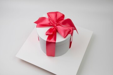 a present box has a red ribbon on top of it