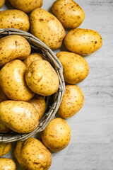 Fresh potatoes. On white table.