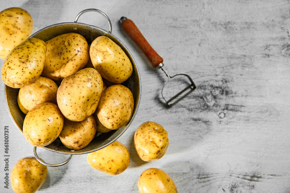 Canvas Prints Fresh potatoes. On white table.