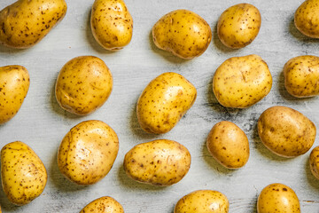 Fresh potatoes. On white table.