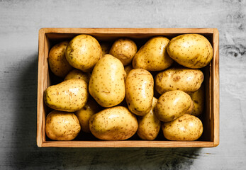 Fresh potatoes. On white table.