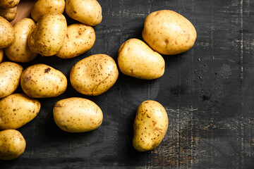 Fresh potatoes. On black background.