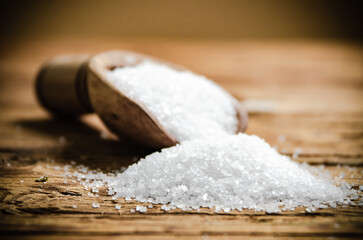 Salt background . On wooden table.