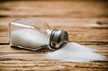 Salt background . On wooden table.